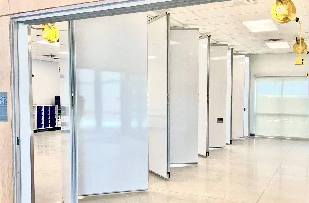 Modernfold Acousti-Seal operable walls divide a large office space.