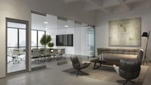 Modernfold ComfortDrive glass walls divide a conference room from a waiting room.