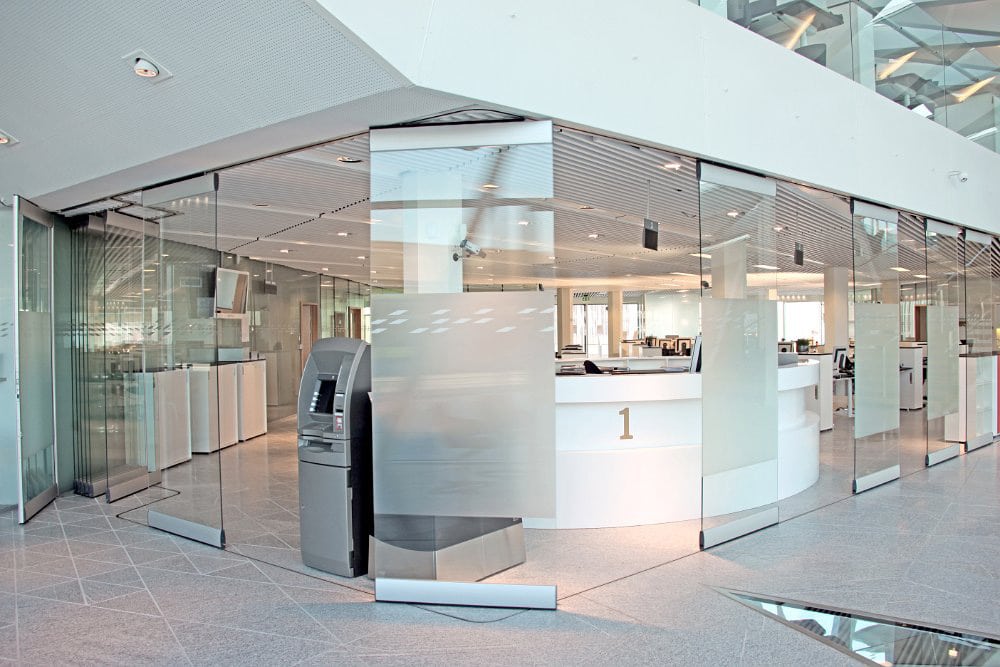 Modernfold ComfortDrive operable glass partition walls in a bank.