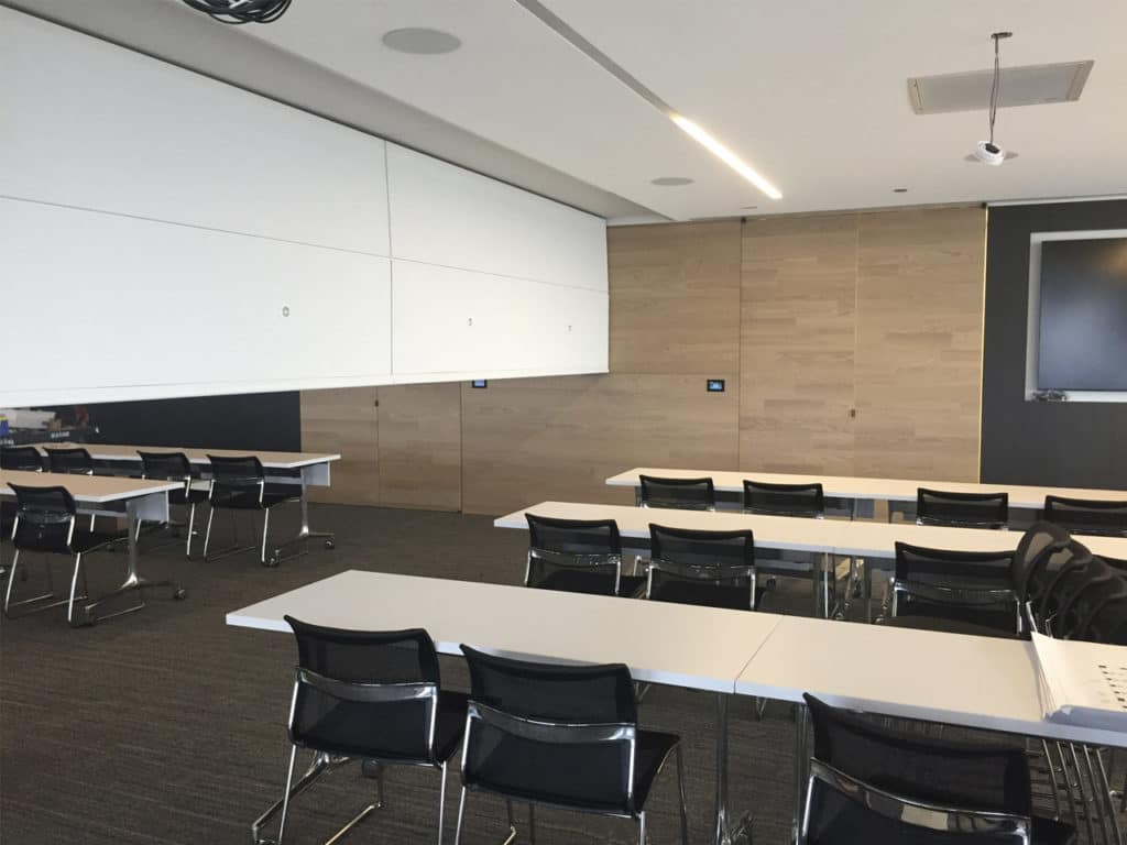 Skyfold Zenith Premium operable wall partially retracted in a classroom.