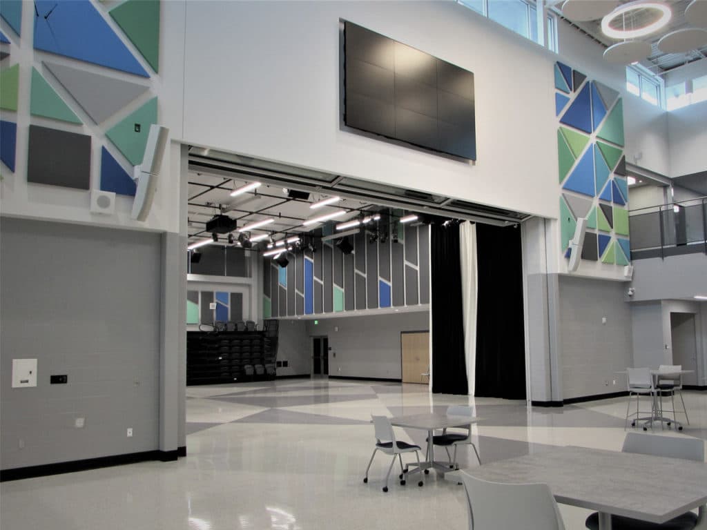 Skyfold Mirage glass operable wall fully retracted in a university interior courtyard.