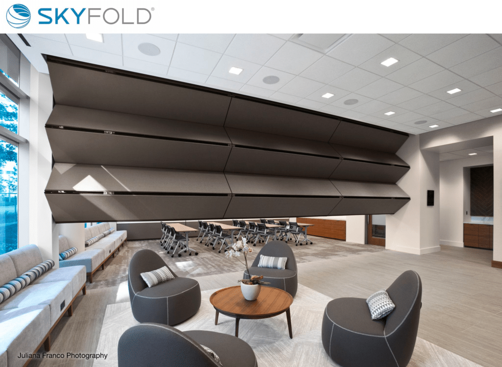 Skyfold operable wall dividing an office space.