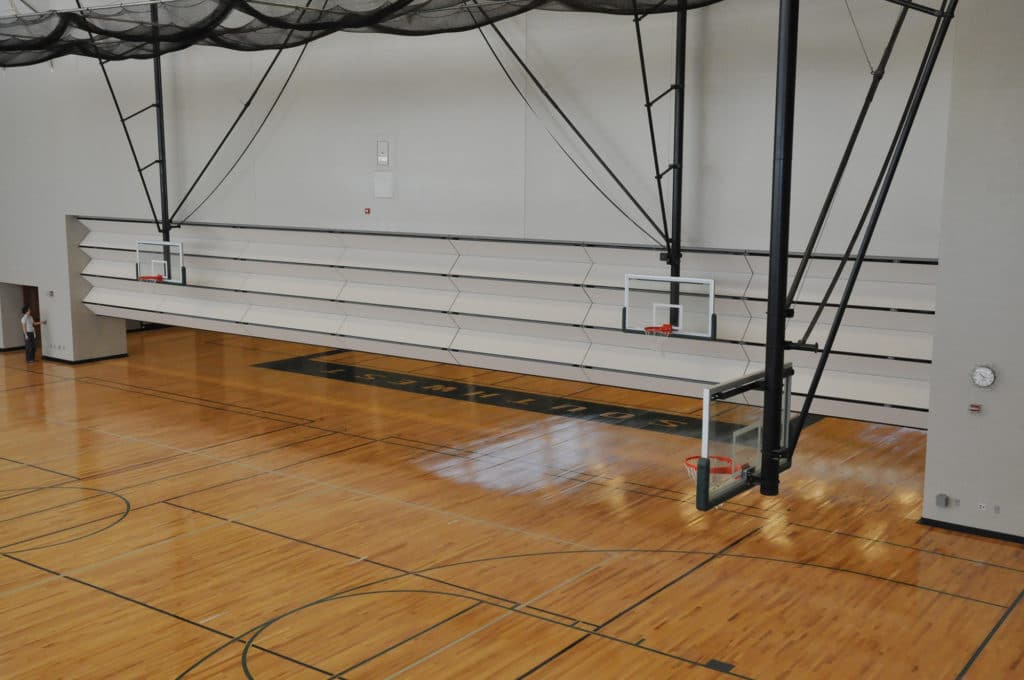 Skyfold operable wall partially retracted in Blue Valley Southwest High School gym.
