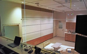 Fully extended operable wall dividing a patient room from the rest of the hospital.