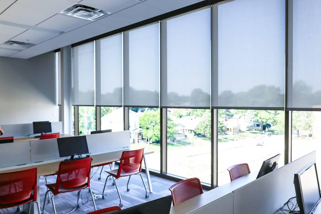 HIgh school classroom with floor-to-ceiling commercial rollershades.
