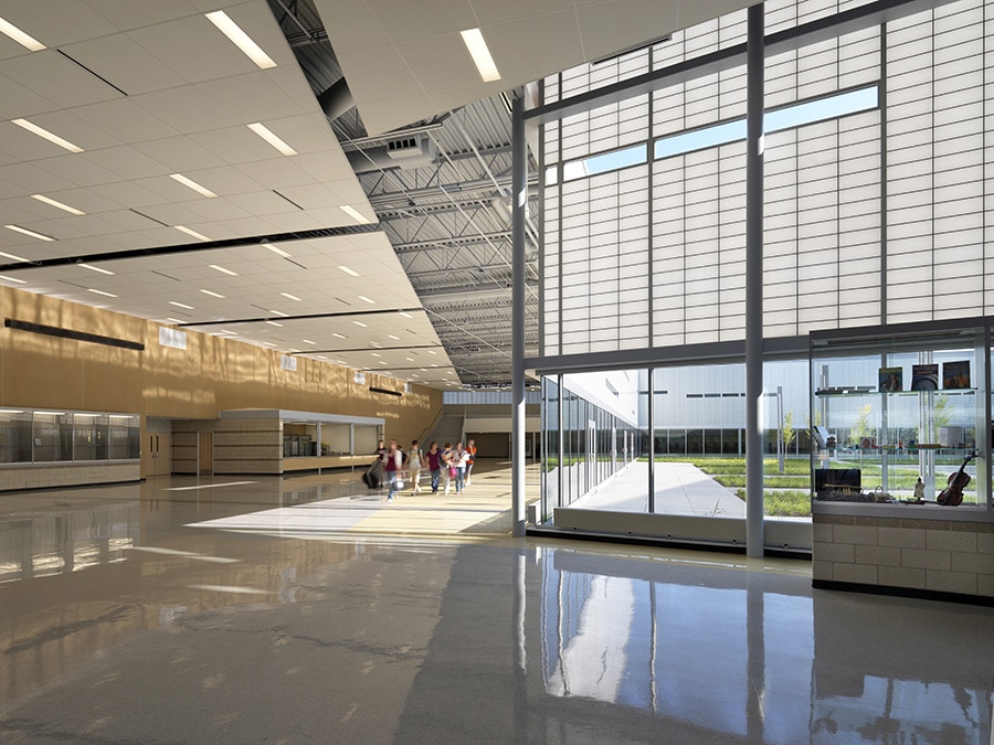School atrium with translucent facade panels to control daylighting