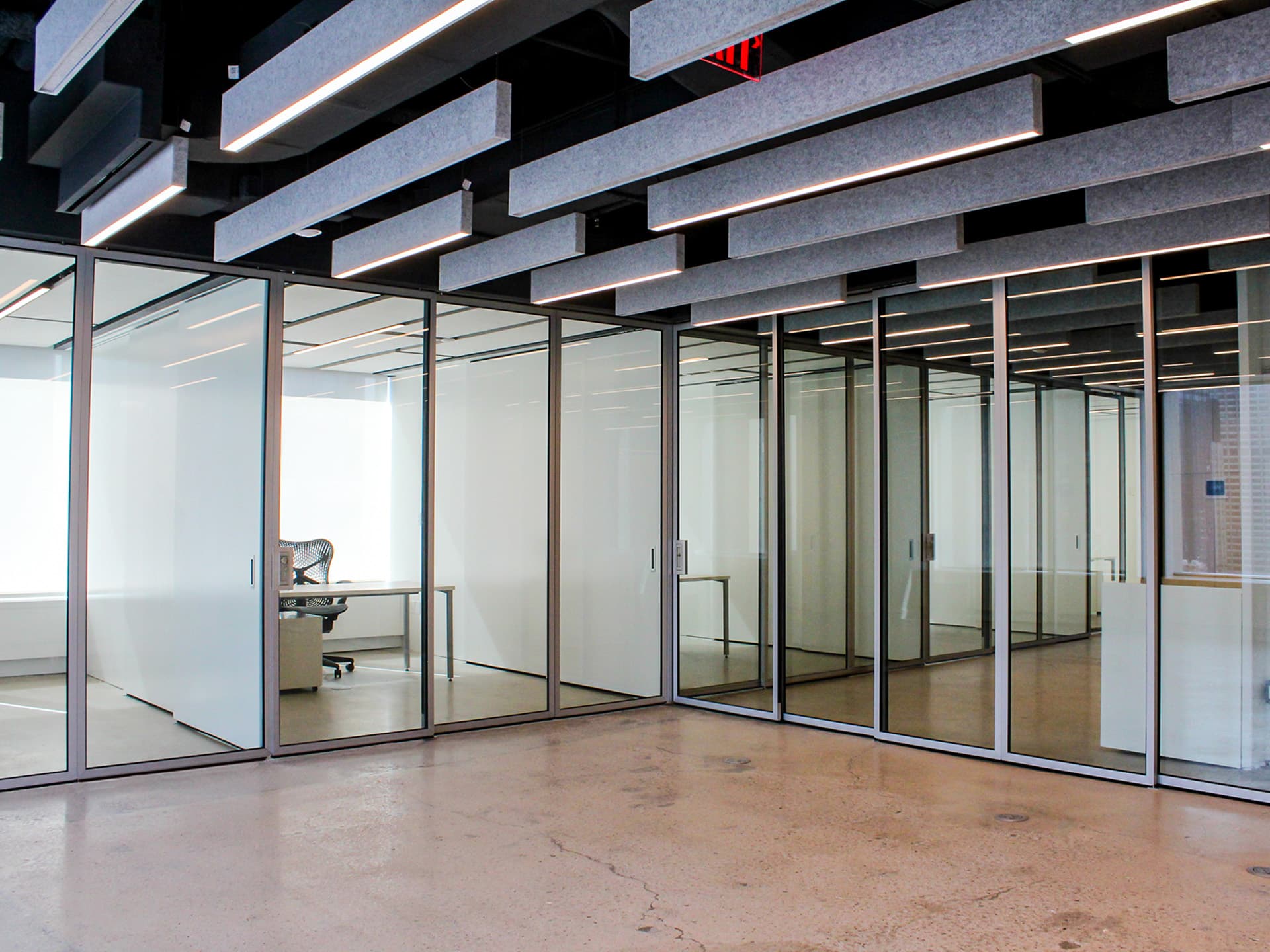 ZONA telescoping glass walls in an office interior.
