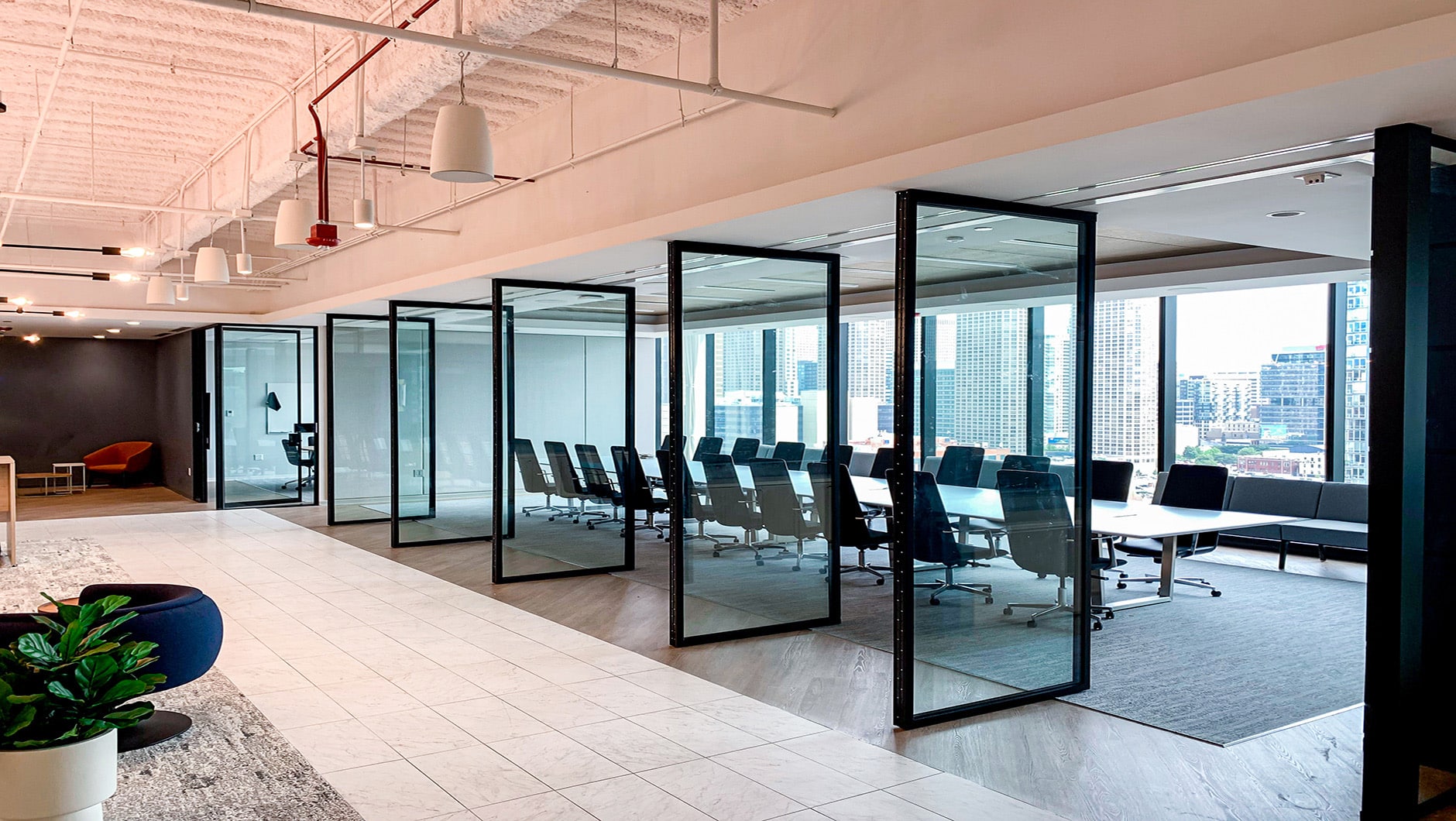 Office conference room with glass walls open.