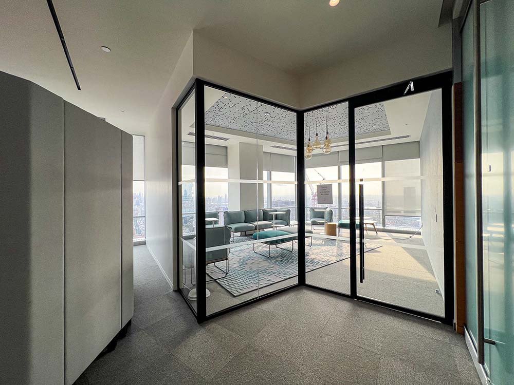 An office lounge with Zona Glass walls and door.